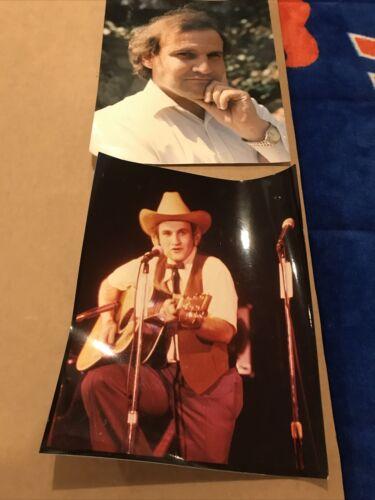 Floyd Vivino performing onstage in a cowboy costume with a guitar